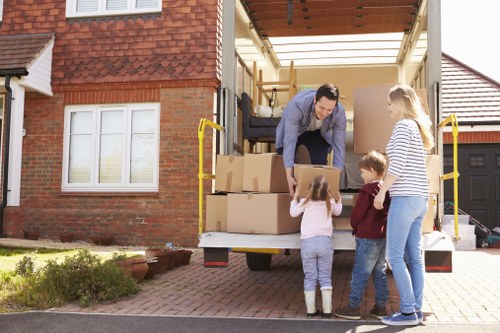 Man and van team loading household items into a vehicle
