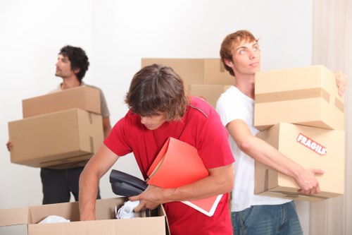 Worker assessing a removal item before lifting during a house move
